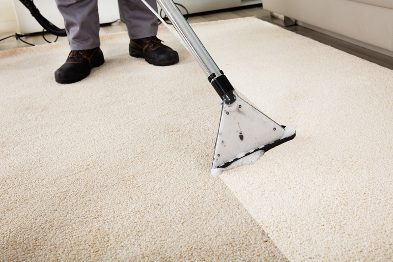 Man Vacuuming Carpet